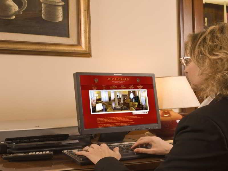 Hotel Vittoria Pesaro Exterior photo A hotel employee working on a computer